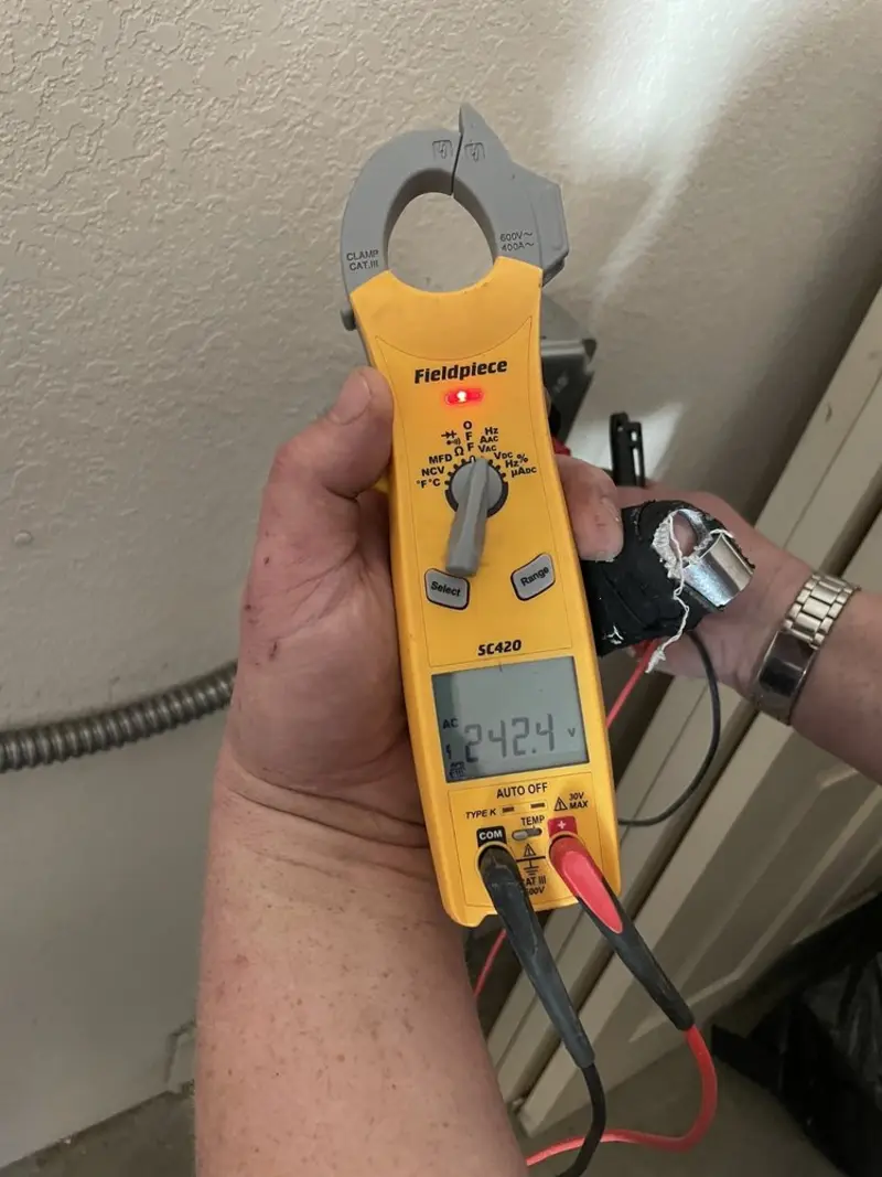 Voltage testing with clamp meter during Ceiling Fan Installation in Wingate
